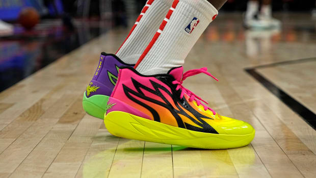 View of pink and yellow Puma shoes.